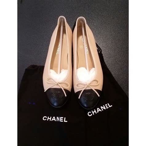 chanel beige black ballerina flats.